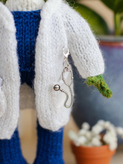 Keychain with a hook attached to a knitted item, with a blurred background
