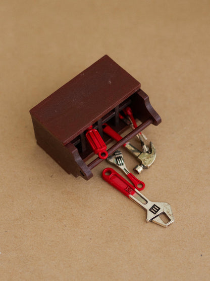 Toy tool chest with tools on a brown background